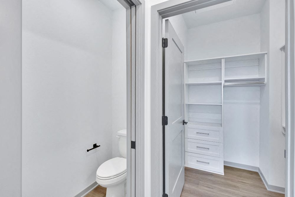 View from master bath of toilet and custom built closet